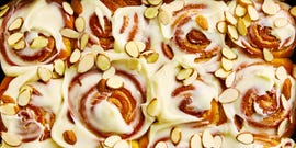 cinnamon rolls with cream cheese icing and sliced almonds