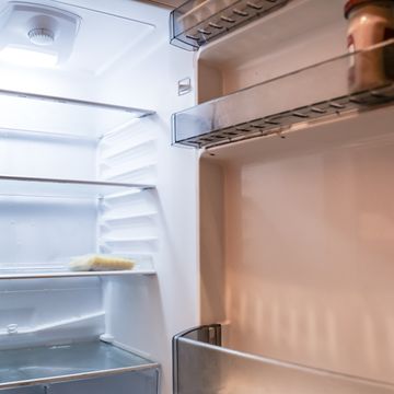 almost empty refrigerator with open door