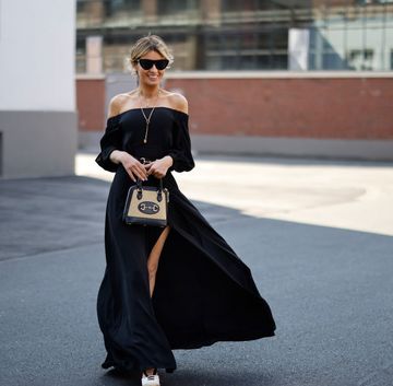 dusseldorf, germany june 04 influencer gitta banko wearing an elegant black off shoulder maxi dress u2018gabinou2019 with leg slits by nicowa, beige and black wedges by schutz, a black belt with gold detail by gucci, sunglasses by bottega veneta, a beige and black bag by gucci, a long gold necklace by lennart marlon and a gold lion necklace by alighieri during a street style shooting on june 4, 2021 in dusseldorf, germany photo by streetstyleshootersgetty images