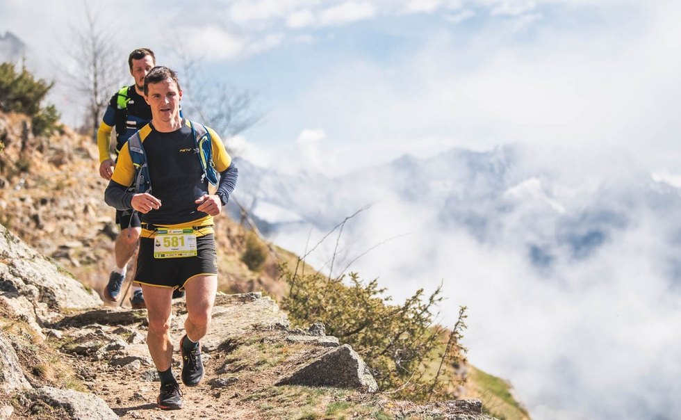 a group of people running on a mountain