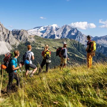 alpine mountain guide climbing with family hiking group