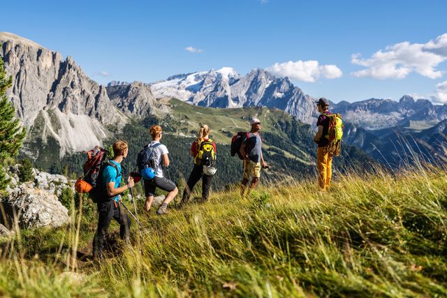 alpine mountain guide climbing with family hiking group