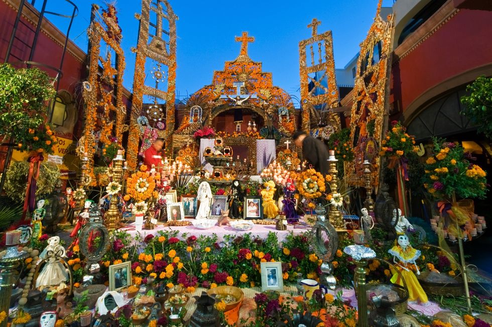 Goudsbloemen en familiefotos sieren een altaar ter ere van Da de los Muertos in San Miguel de Allende in Mexico