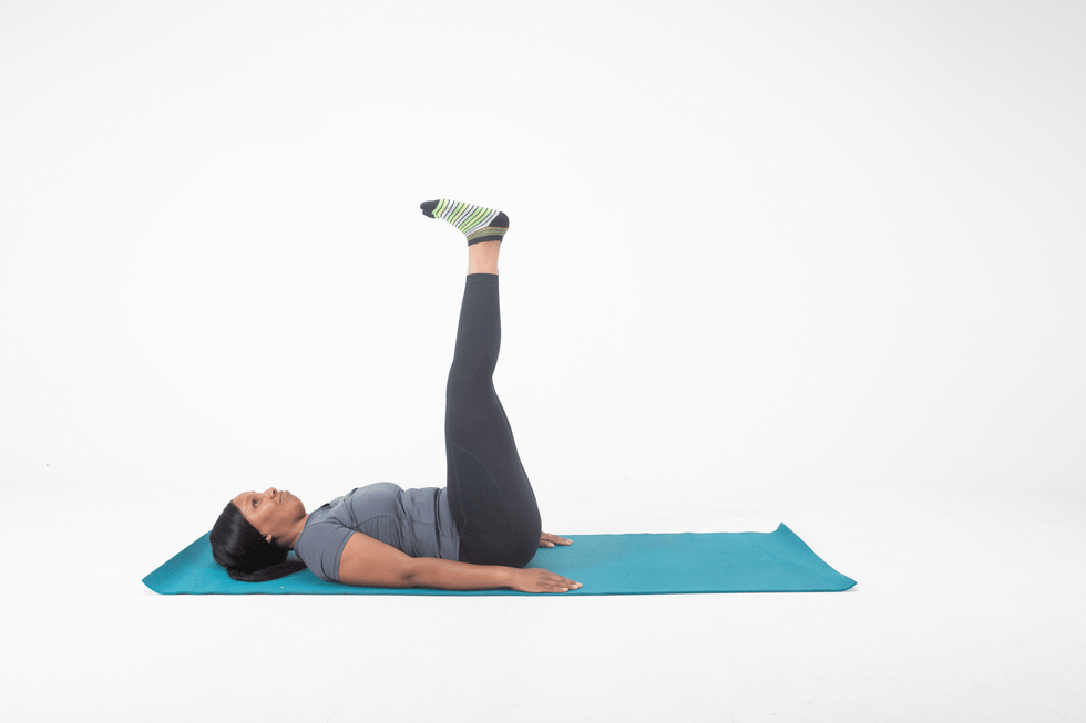 person performing a leg raise exercise on a yoga mat