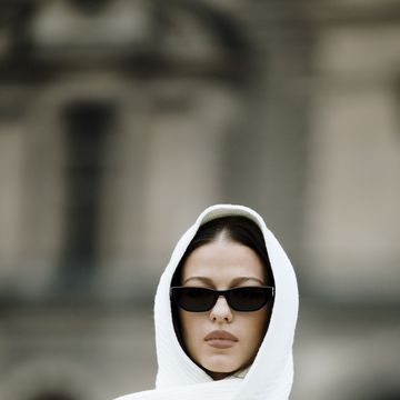 a person wearing a white robe and sunglasses