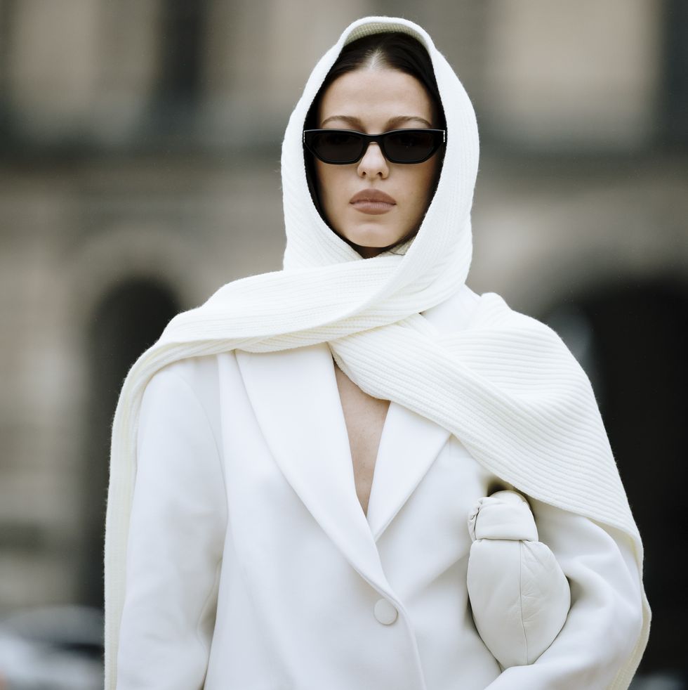 a person wearing a white robe and sunglasses