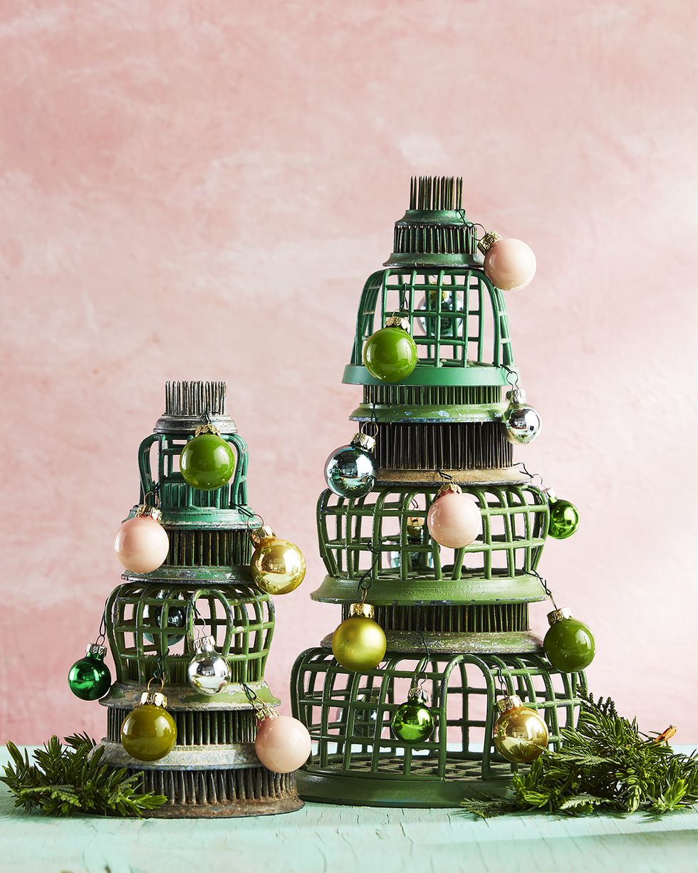 flower frogs stacked in the shape of a tree with tiny ornaments alternative christmas tree