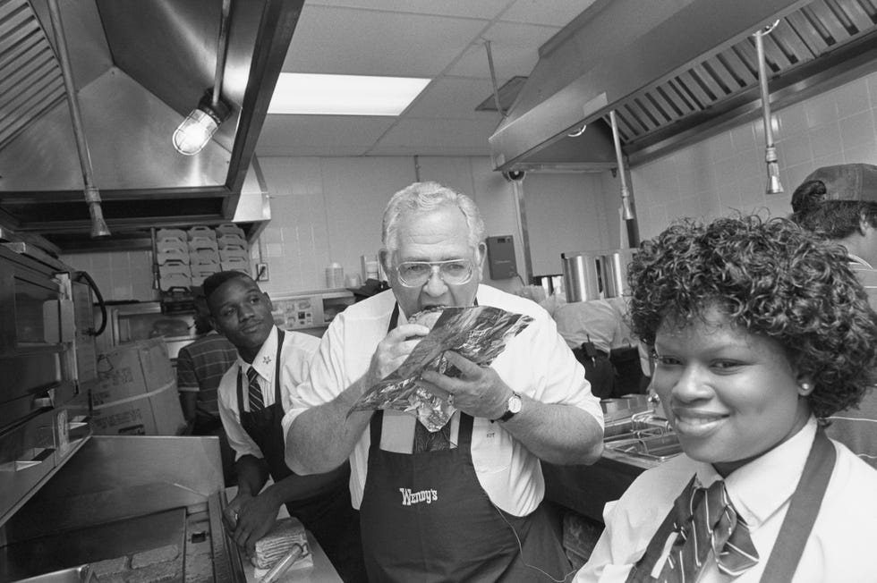 dave thomas eating a hamburger