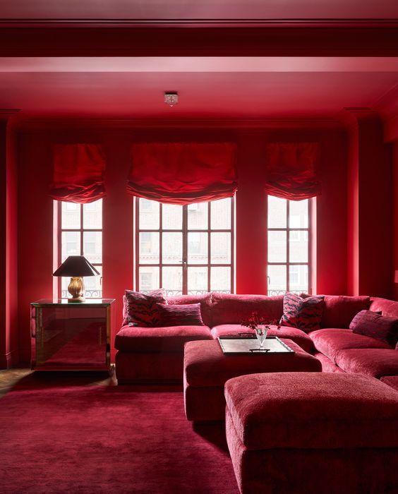 a living room with red couches