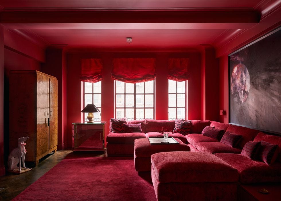 a living room with red couches