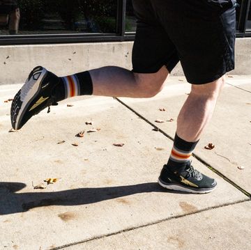 a person's legs and feet while running in zero drop shoes