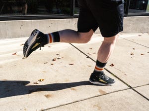 a person's legs and feet while running in zero drop shoes