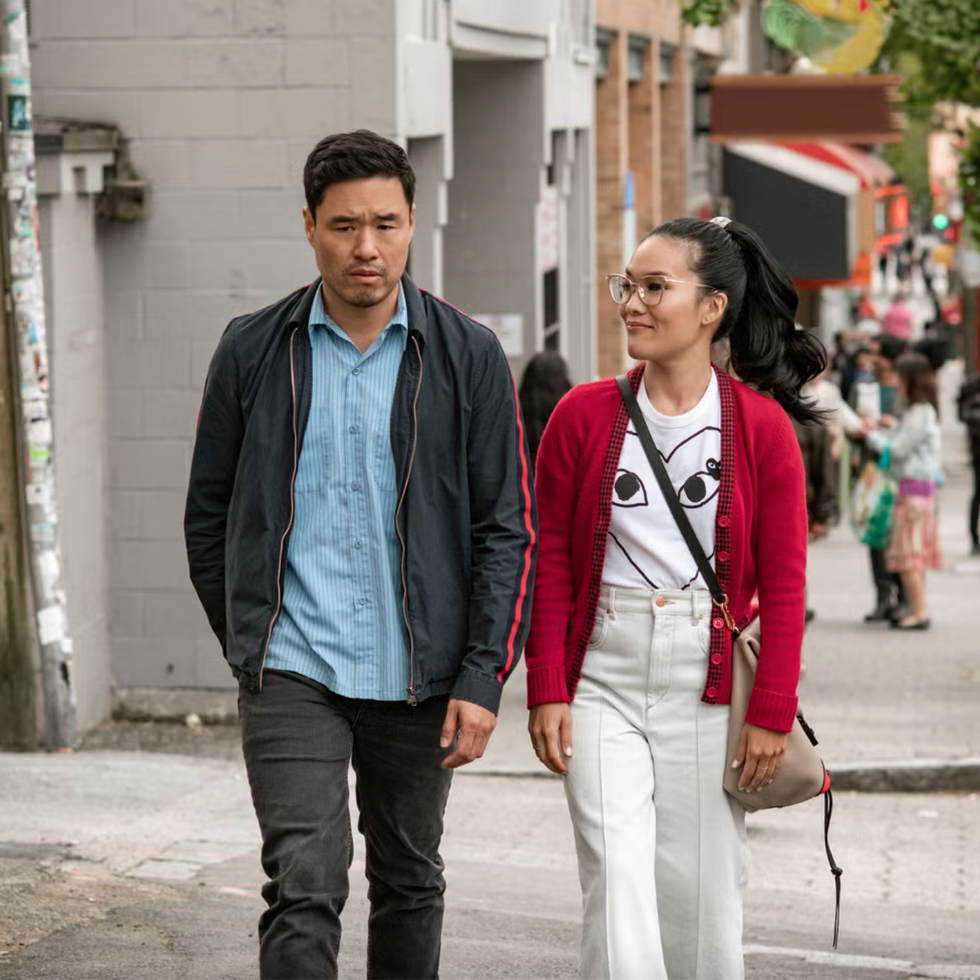two people walking on a city street two people walking on a city street
