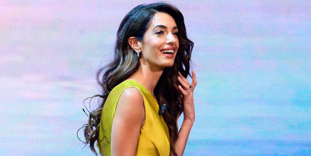 Amal Clooney wears a metallic gold jumpsuit to speak at a conference