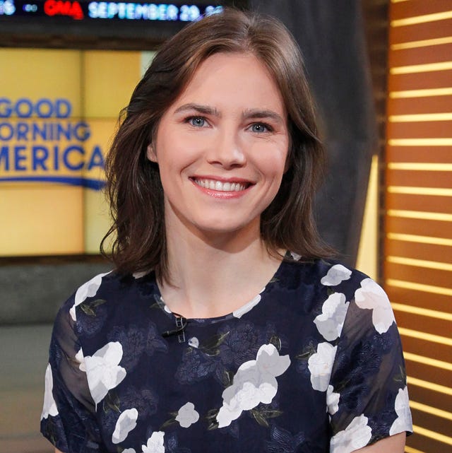 amanda knox sitting at a desk and smiling