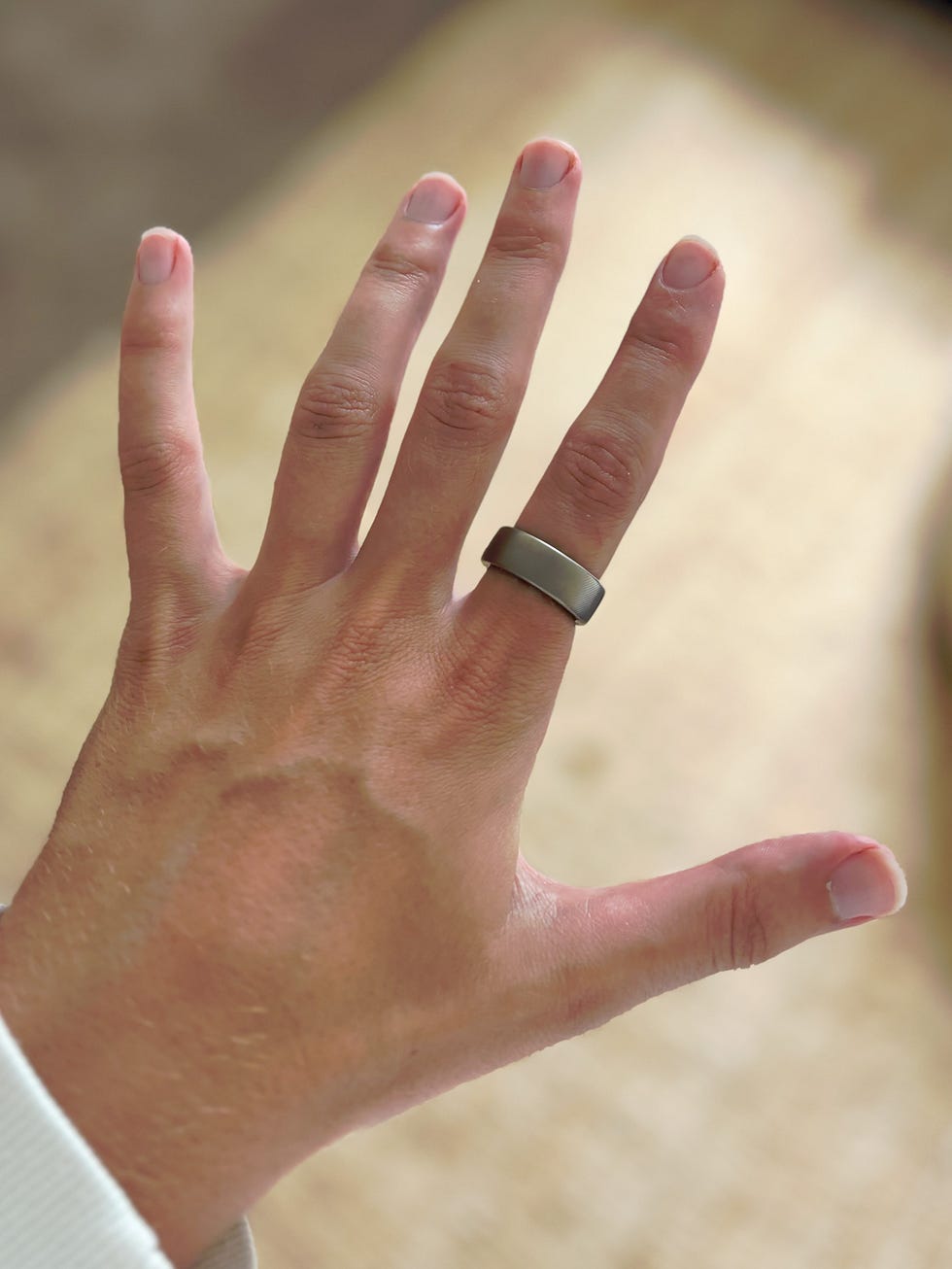 a hand wearing a smart ring