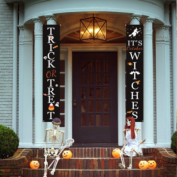 front porch with halloween banners and hocus pocus pillows and pumpkins
