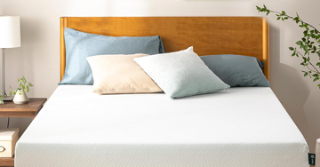 bed with colorful pillows and a wooden headboard