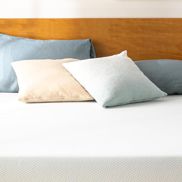 bed with colorful pillows and a wooden headboard bed with colorful pillows and a wooden headboard