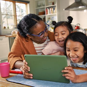 family laughing at amazon fire tablets