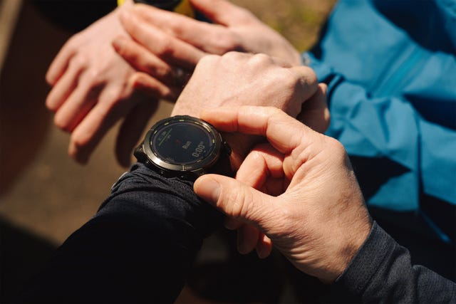 person loading up their running watch