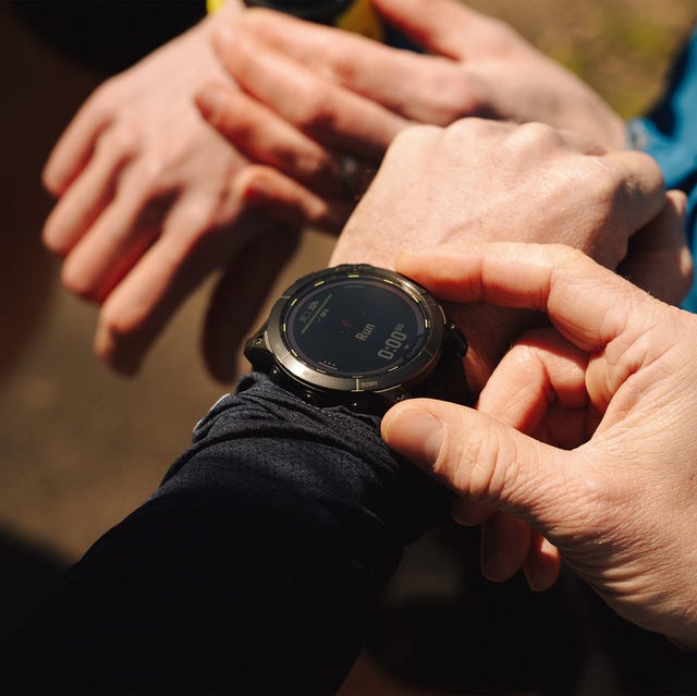 person loading up their running watch person loading up their running watch