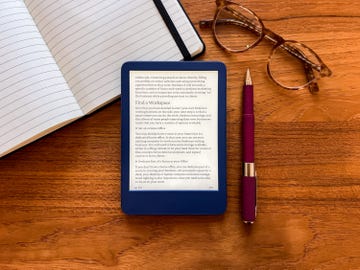 amazon kindle with notebook, pen, glasses