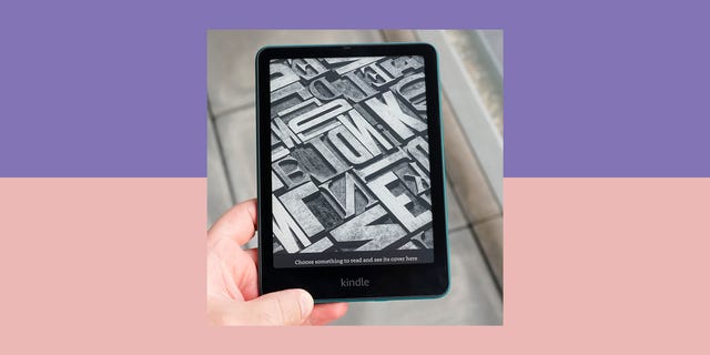 an kindle paperwhite ereader displaying a typographic pattern on its screen held by a persons hand