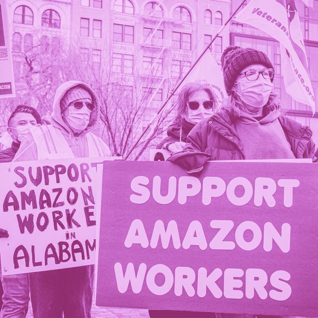 protesters holding signs that say "support amazon workers" and "support amazon workers in alabama"