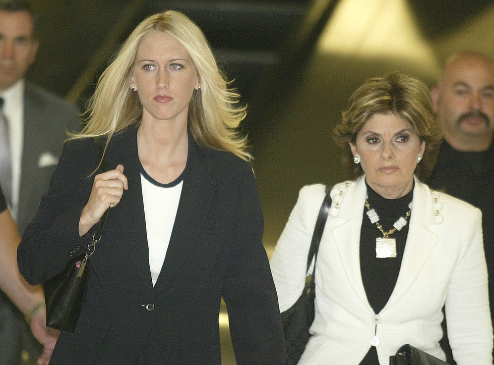 two women in business jackets and formal shirts walk next to each other and look to either side