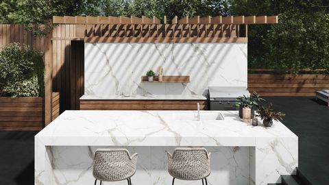 an outdoor kitchen setup with stone counters