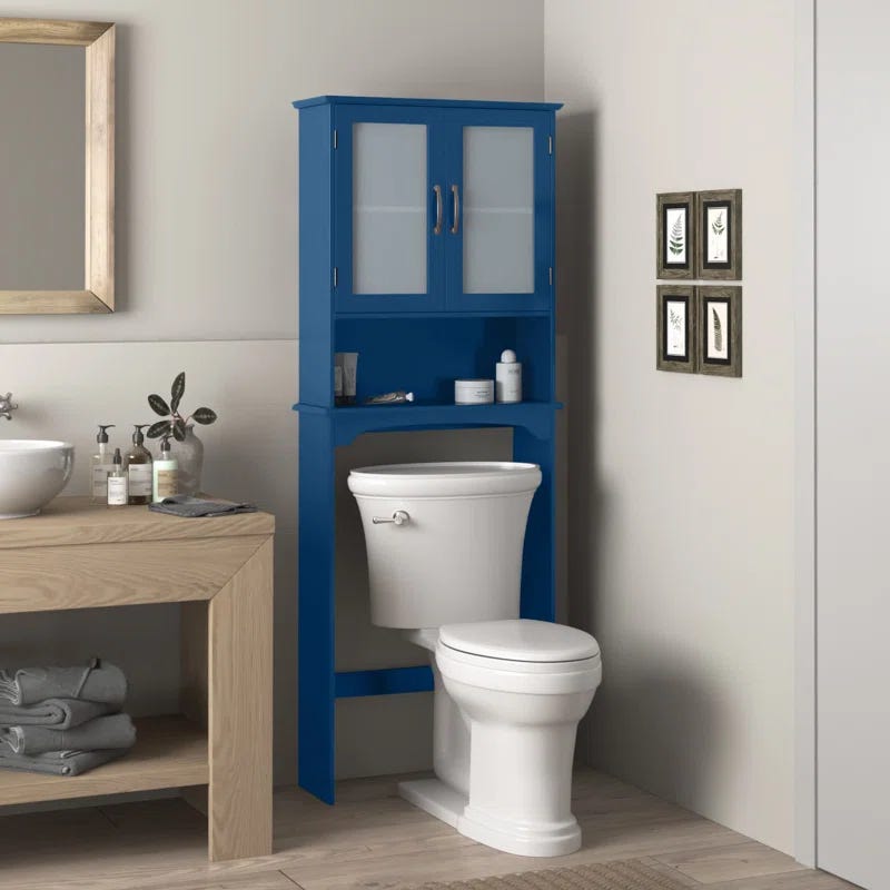 bathroom with a blue storage cabinet over a white toilet and a wooden vanity