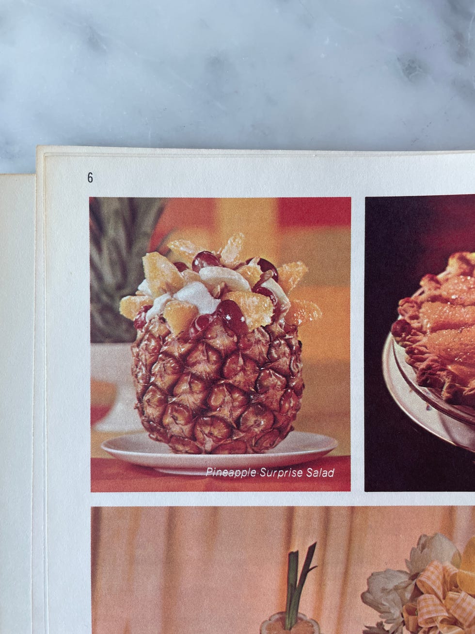 book with an image of an ambrosia salad in a pineapple
