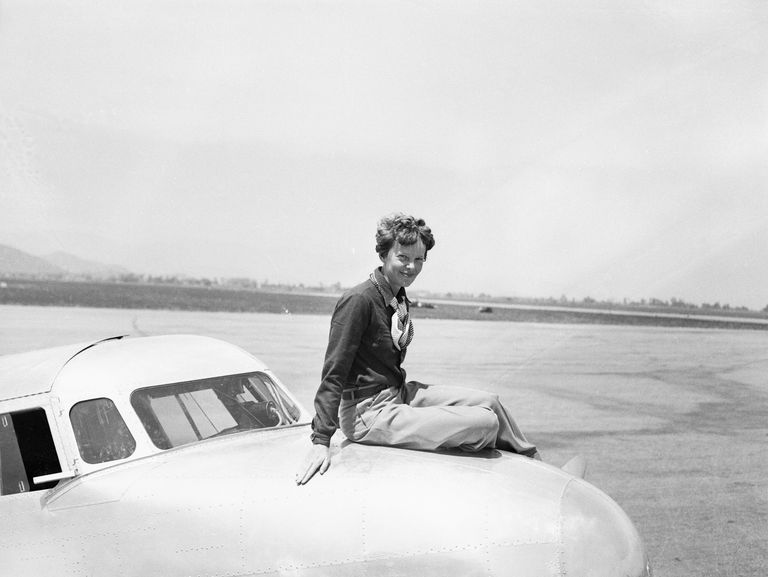Aviatrix Amelia Earhart Posing on Airplane