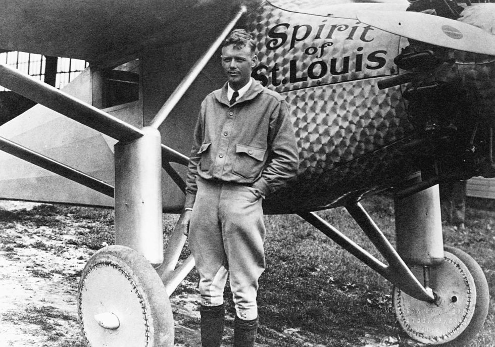 charles lindbergh stands in front of his plane spirit of st louis
