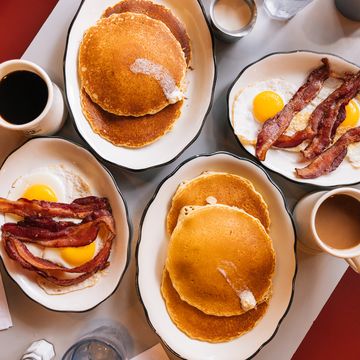 american breakfast at the diner with fried eggs, bacon and pancakes