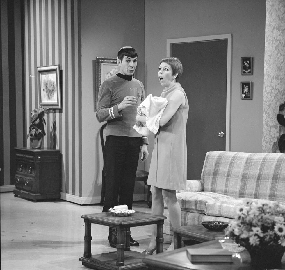leonard nimoy and carol burnett in character for the carol burnett show, they stand in a living room with carol looking shocked