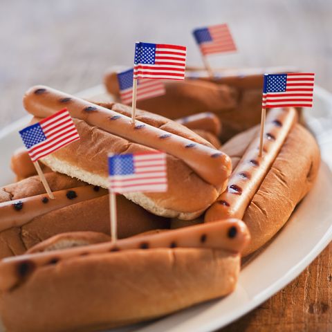 little american flags in grilled hot dogs on buns