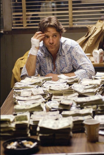 a woman sitting at a table with stacks of paper