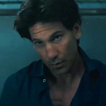 jon bernthal in american gigolo in a blue shirt in an interrogation room