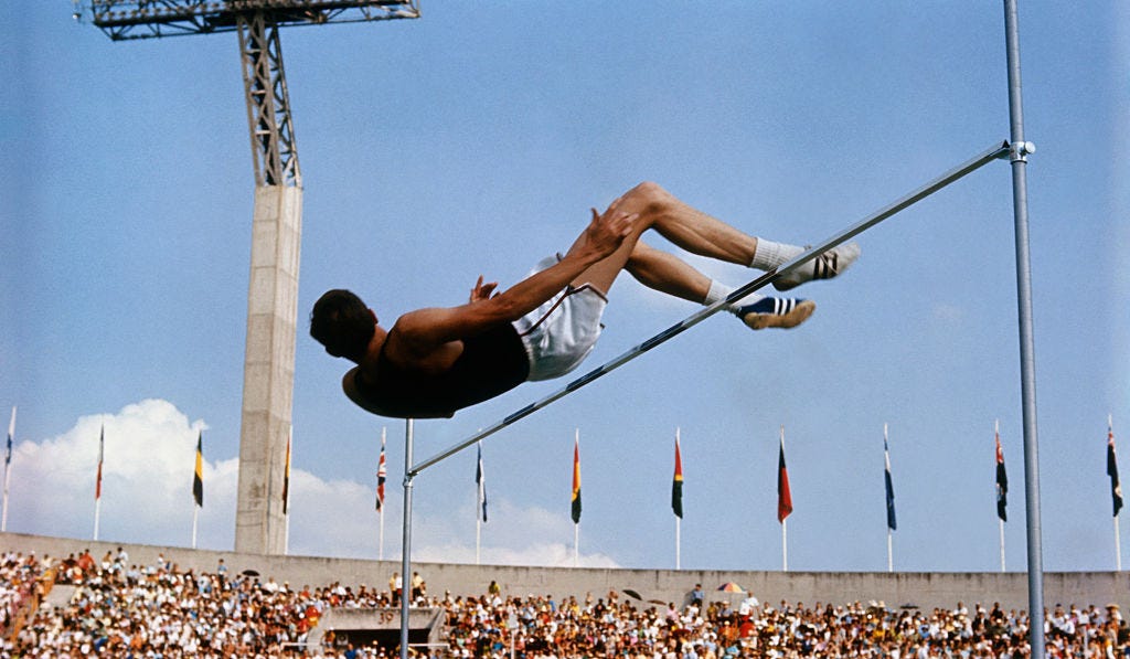 dick fosbury sailing over bar at 1968 olympic games