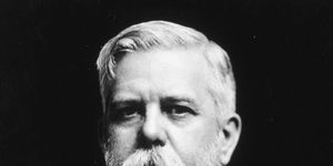 george westinghouse looks at the camera, he wears a suit jacket and tie with a collared shirt and has a large mustache