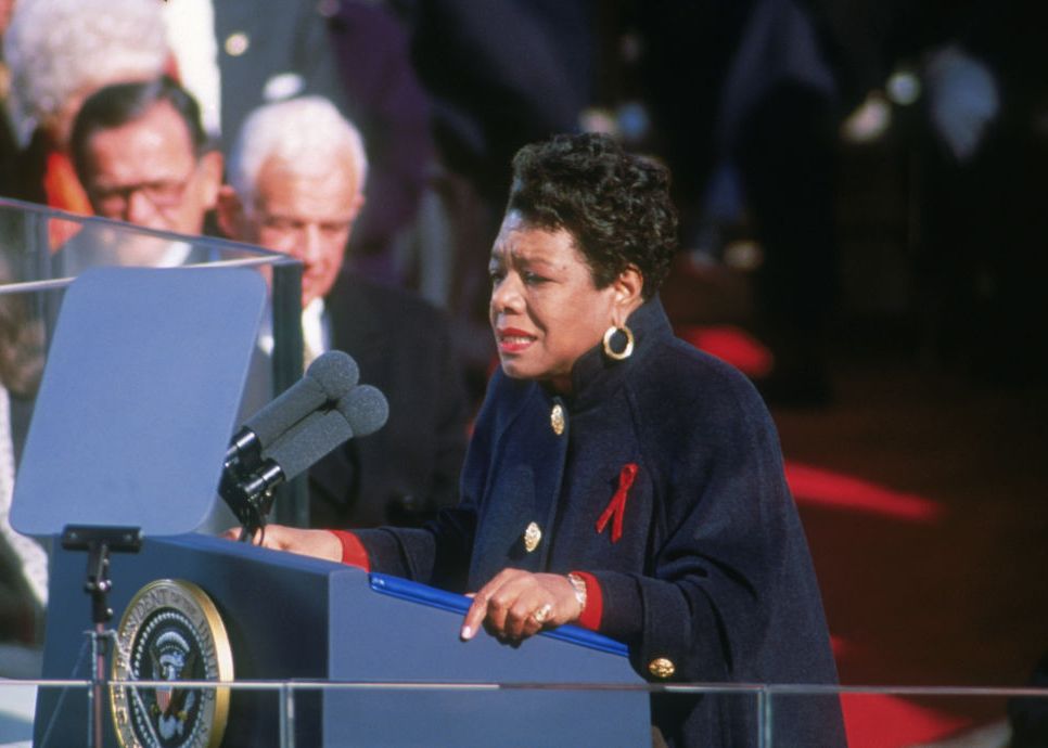 maya angelou reading a poem a a presidential podium while attendees look on