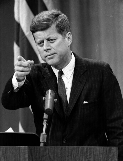 making ajfk at a podium with microphone, pointing his finger point