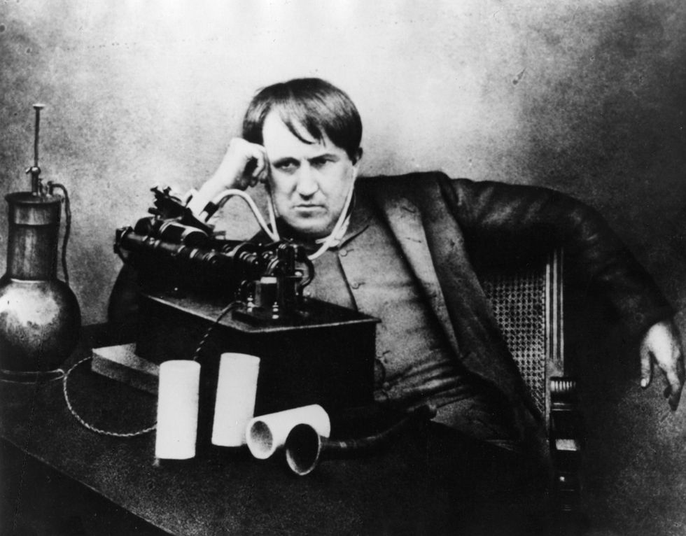 Thomas Edison listening to a phonograph through a primitive headphone