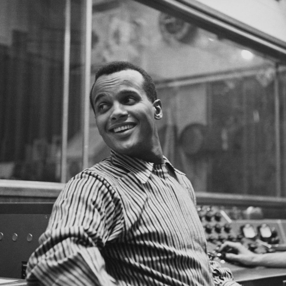 american singer songwriter and civil rights activist harry belafonte, wearing a striped shirt, in an recording studio, circa 1957. the sound engineer is visible working at the console to the right of the frame. (photo by archive photos/hulton archive/getty images)