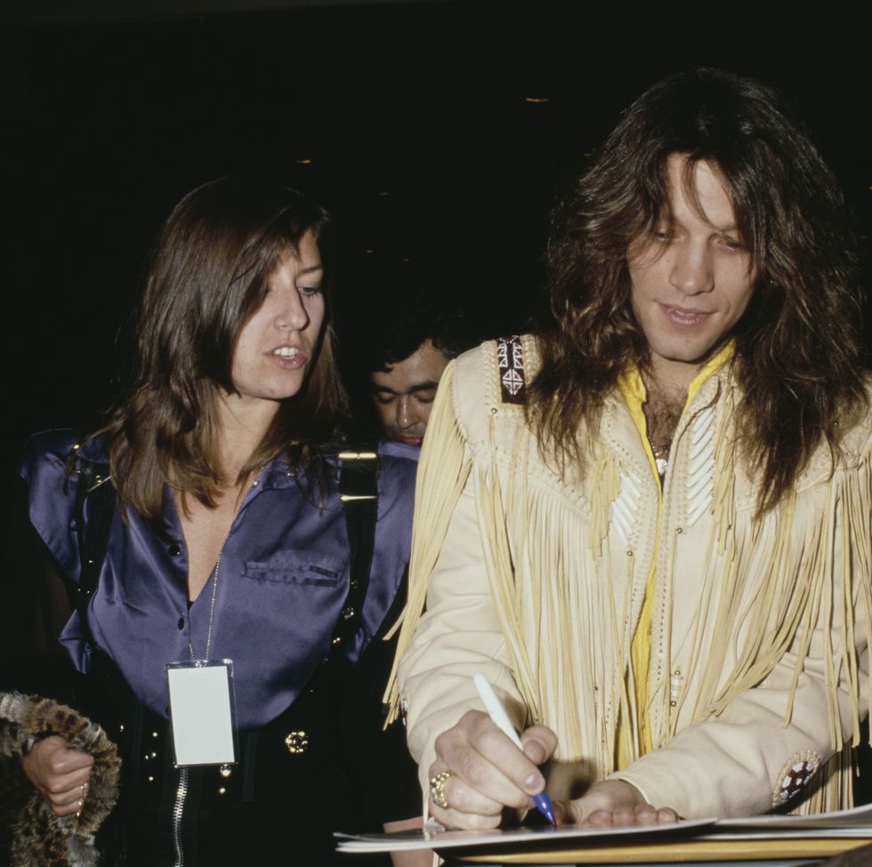 jon signing autographs for fans alongside his wife, dorothea, circa 1990