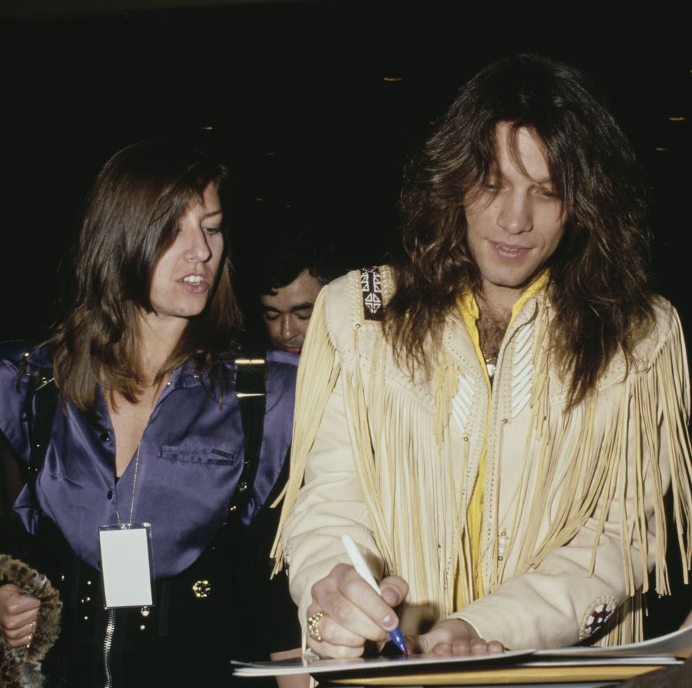 jon signing autographs for fans alongside his wife, dorothea, circa 1990