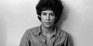 eric carmen sitting against a wall for a black and white portrait photo