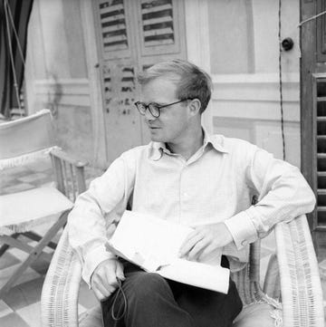 truman capote holding an envelope